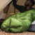 an in use photo of a person utilizing their synthetic insulated sleeping quilt with the foot box closed