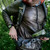 in action shot of a men's Graphite shell lightweight, warm, wind protection, and, moisture resistant, insulated, jacket with Salmon orange liner being used to hike in the woods