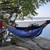 a in use photo of a navy and charcoal custom revolt apex custom quilt hanging on a tree by a lake north in minnesota